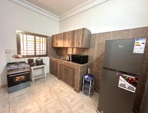 a kitchen with a refrigerator and a stove at Résidence du Golf in Bamako
