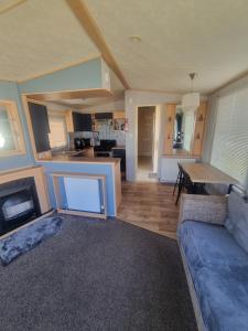 a large living room with a couch and a table at 3 bed 2 bath Static on parkdean morecambe in Morecambe