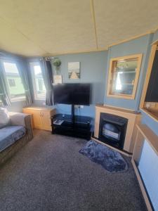 a living room with a television and a fireplace at 3 bed 2 bath Static on parkdean morecambe in Morecambe