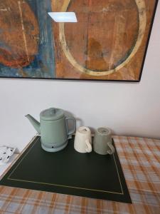 a table with two mugs and a painting at dalcom kunkuk in Seoul