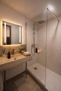 a bathroom with a shower and a sink at Trianon Location in Bagnols-en-Forêt +28 photos