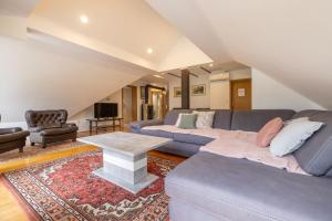 a living room with a couch and a table at Rooms Hrominc in Bled