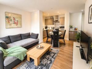 a living room with a couch and a table at Apartment 3 in Birmingham