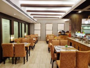 a dining room with wooden tables and chairs at SK Premium Park GGN in Gurgaon