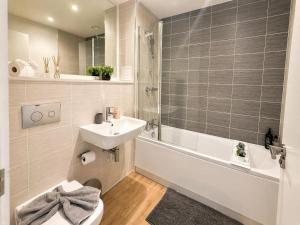 a bathroom with a sink and a toilet and a bath tub at Apartment 3 in Birmingham +19 photos