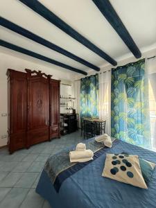 a bedroom with a blue bed with towels on it at Hellas Makari B&B in Macari