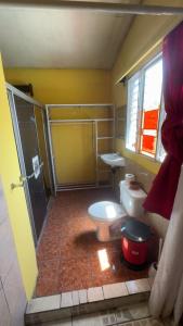 a bathroom with a toilet and a shower and a sink at Accommodation in Copán Ruinas #6 in Copán Ruinas