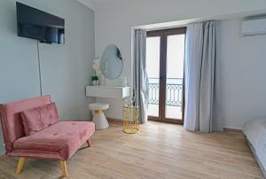 a living room with a couch and a chair at Galaris' Studio in Samos