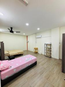 a room with two beds and a ceiling fan at May Ong Guest House in Taiping +10 photos