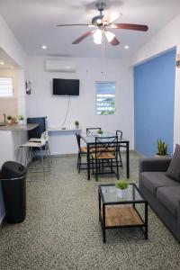 a living room with a couch and a table at Emmanuelli Sur 7 Bedroom Mall of San Juan Home in San Juan
