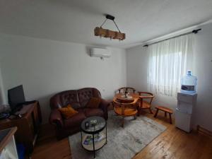 a living room with a couch and a table at Eco House Nevidio in Šavnik