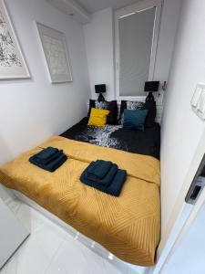 a bedroom with a bed with two towels on it at Luksusowy Apartament Giżycko in Giżycko