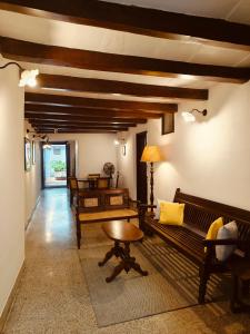 a room with benches and a table in a room at Ezekiel House Residence in Cochin