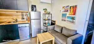 a small living room with a couch and a kitchen at SAK Mobile Home Privlaka in Privlaka +16 photos