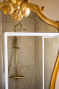 a shower with a shower head in a bathroom at Villa Hermès in La Flocellière