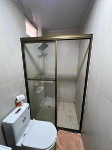 a small bathroom with a toilet and a shower at Hotel Cristina in Bocas Town +36 photos
