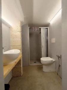 a bathroom with a sink and a toilet and a shower at Minuetto 60 in Ostuni +4 photos
