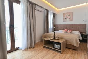 a hotel room with a bed and a table at Galaris' Luxury Room in Kokkari