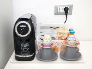 a black blender sitting on a shelf next to a microwave at Donna Marianna in Vieste
