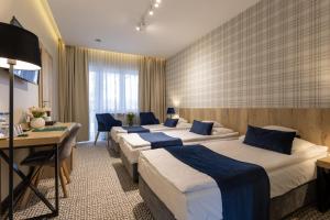 a row of beds in a hotel room at Hotel Wojciech in Augustów