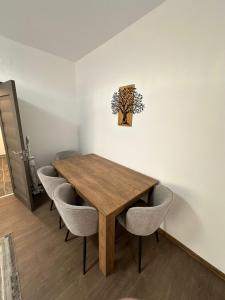 a dining room with a wooden table and chairs at Matei's Apartment by the Sea in Constanţa