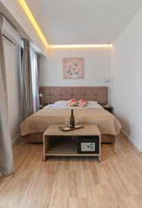 a bedroom with a bed and a table in front of it at Galaris' Luxury Room in Kokkari