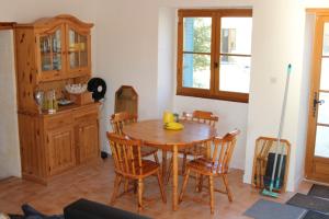 a dining room with a wooden table and chairs at Au Charme Charentais Gite geel in Blanzaguet-Saint-Cybard-le-Peyrat