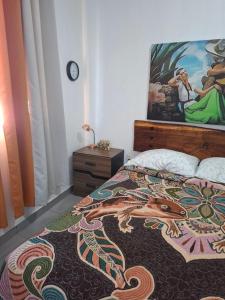 a bedroom with a bed with a dragon design on it at Hospedaje Samao in Santa María del Oro