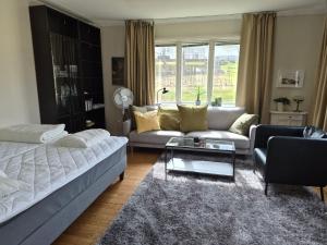 a living room with a couch and a table at Lägenhet i Sandhem in Sandhem