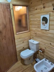 a small bathroom with a toilet and a sink at Alma de Puelo in Lago Puelo +84 photos