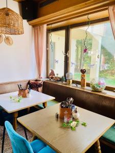 two tables in a restaurant with a window at Frühstückspension Waldeck in Mayrhofen