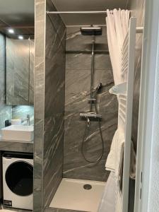 a bathroom with a shower and a sink at Le Reflet du Lac in Malbuisson