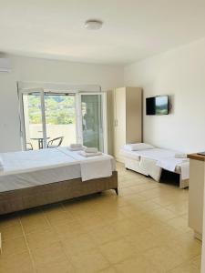 a large room with two beds and a television at Apartmani ,,Del Mar'' in Ulcinj +52 photos