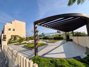 a wooden canopy over a walkway in front of a building at Grand home villas in Jāmb