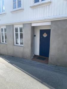 a blue door on the side of a building at The Old Bakery in Grimstad