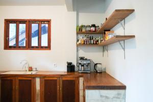 a kitchen with a sink and a counter top at Villa Ombak in Katiet