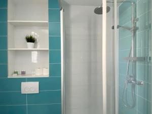 a bathroom with a shower with blue and white tiles at Ksenija Deluxe Residence in Tučepi +23 photos