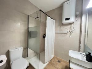 a bathroom with a shower and a toilet and a sink at Todimer Costa Peñon in Torrenueva +14 photos