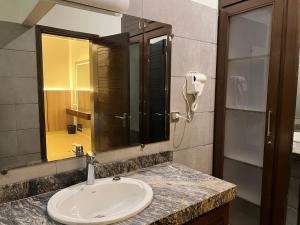 a bathroom with a sink and a mirror at Heritage Heaven by Premium Suites in Karachi +35 photos