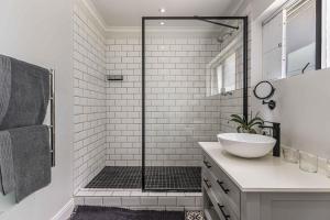 a white bathroom with a sink and a shower at Maroon Belles in Cape Town +22 photos