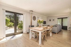 a dining room with a table and a couch at Maroon Belles in Cape Town