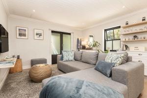 a living room with a couch and a table at Maroon Belles in Cape Town