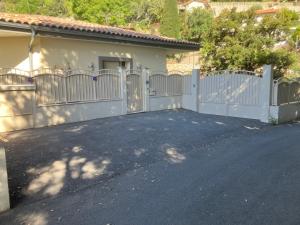 a white fence in front of a house at Chambre indépendante in Saint-Roman