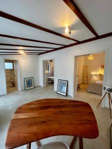 a room with a wooden table and a bedroom at Los Caballos Villa in Cala Galdana