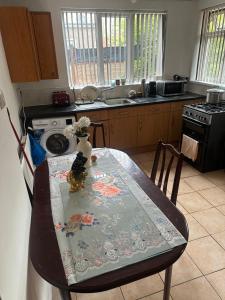 a kitchen with a table with a table cloth on it at Quiet room 5 in Coventry