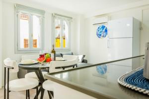a kitchen and dining room with a table and chairs at Westcoast Kalkan Suites 1-bedroom suite located heart of Kalkan Old Town in Kalkan