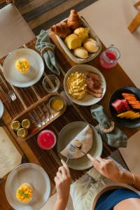 a table with plates of food on it at Villa Das Contas Boutique in Itacaré