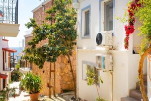 a street in positano with flowers on the side of a building at Westcoast Kalkan Suites 1-bedroom suite located heart of Kalkan Old Town in Kalkan