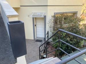a building with a white door and a stair railing at Chambre indépendante in Saint-Roman +6 photos