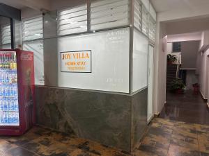 a store with a sign that reads hot villa trump stay hospitality at Joy Villa Homestay in Honāvar